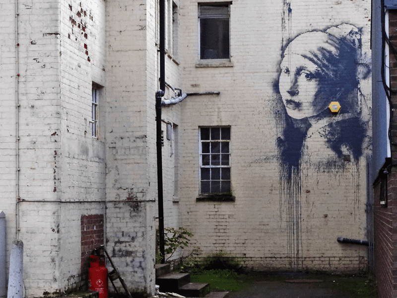 The Girl with the Pierced Eardrum is an street art mural by Banksy in Bristol, England