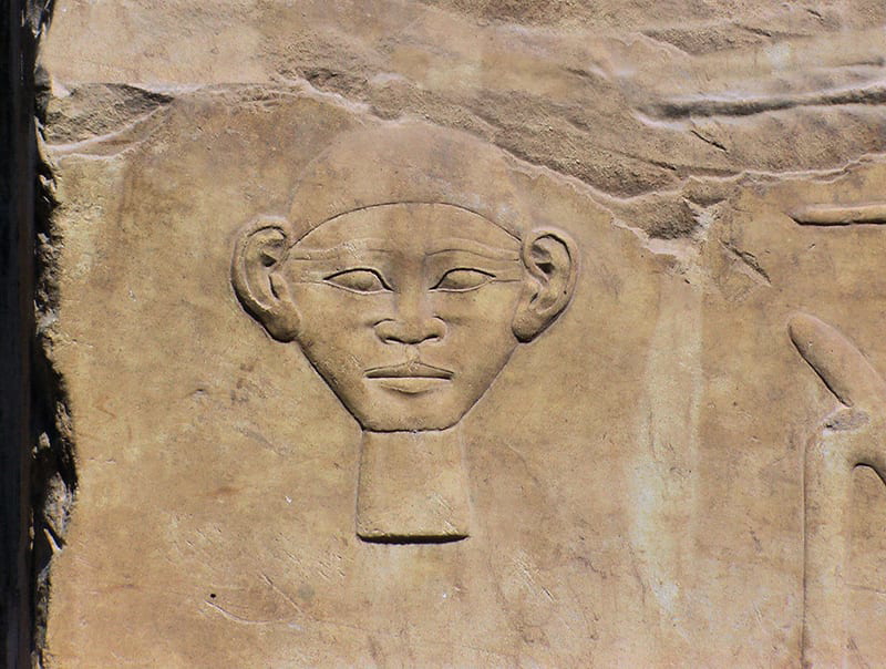 Hieroglyph of human face in raised relief
