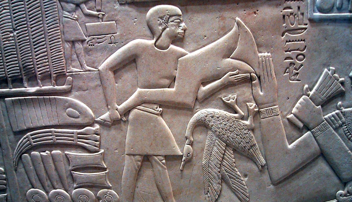 man-offering-foreleg-ox-hieroglyph-egyptian