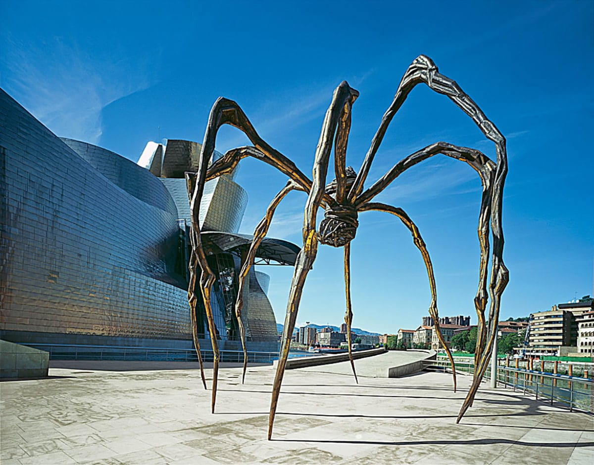 large spider sculpture in front of a museum