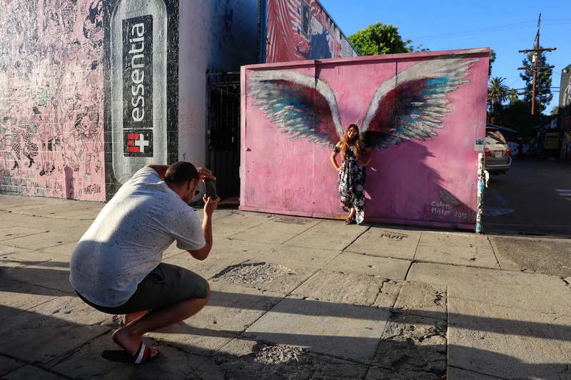 A Tourist posing with Angel Wings by Colette Miller