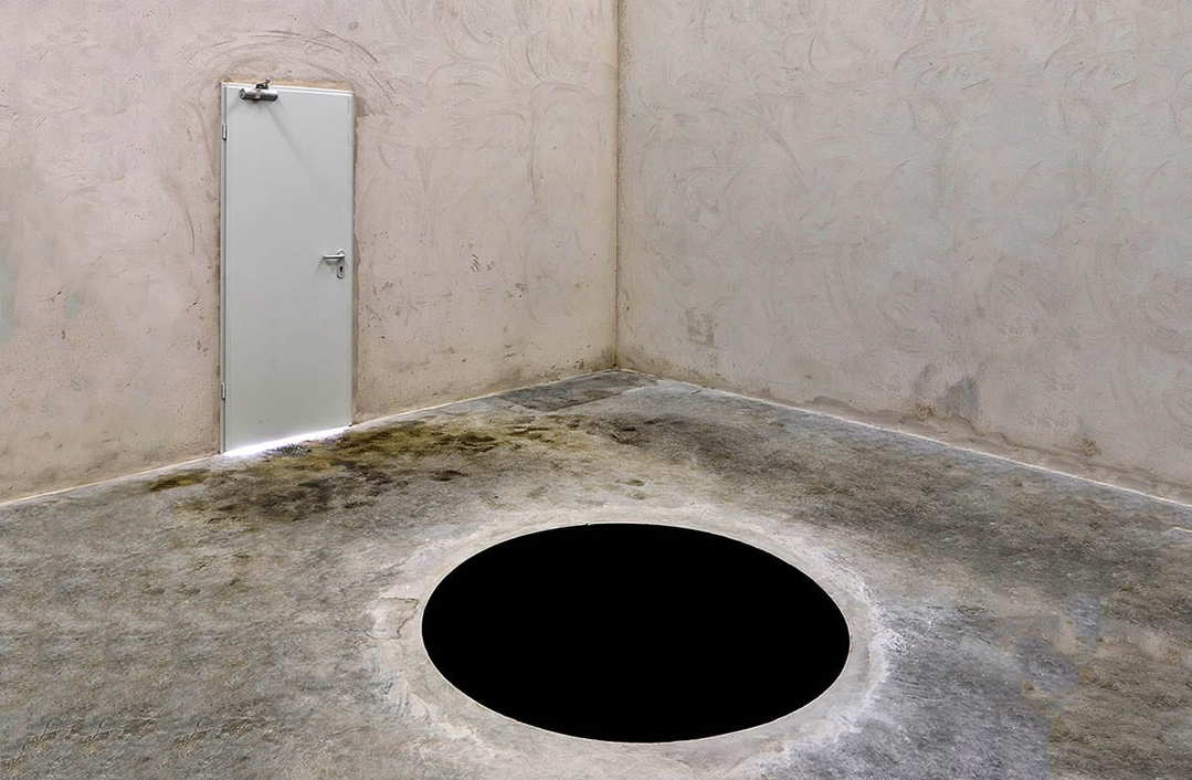 Anish Kapoor's 'Descent into Limbo,' a Vantablack-coated sculpture that appears to be a bottomless pit, inviting viewers to peer into the abyss.