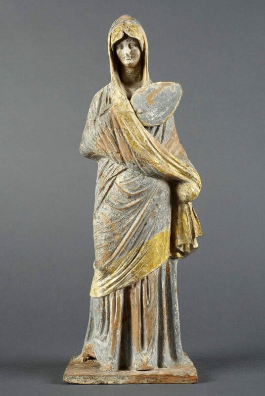 woman in blue tanagra figurine