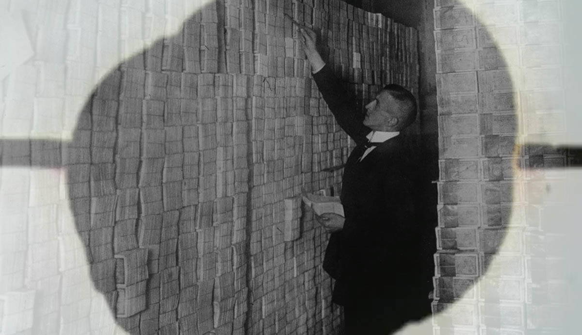 man pilling devalued paper money economic impact post WWI