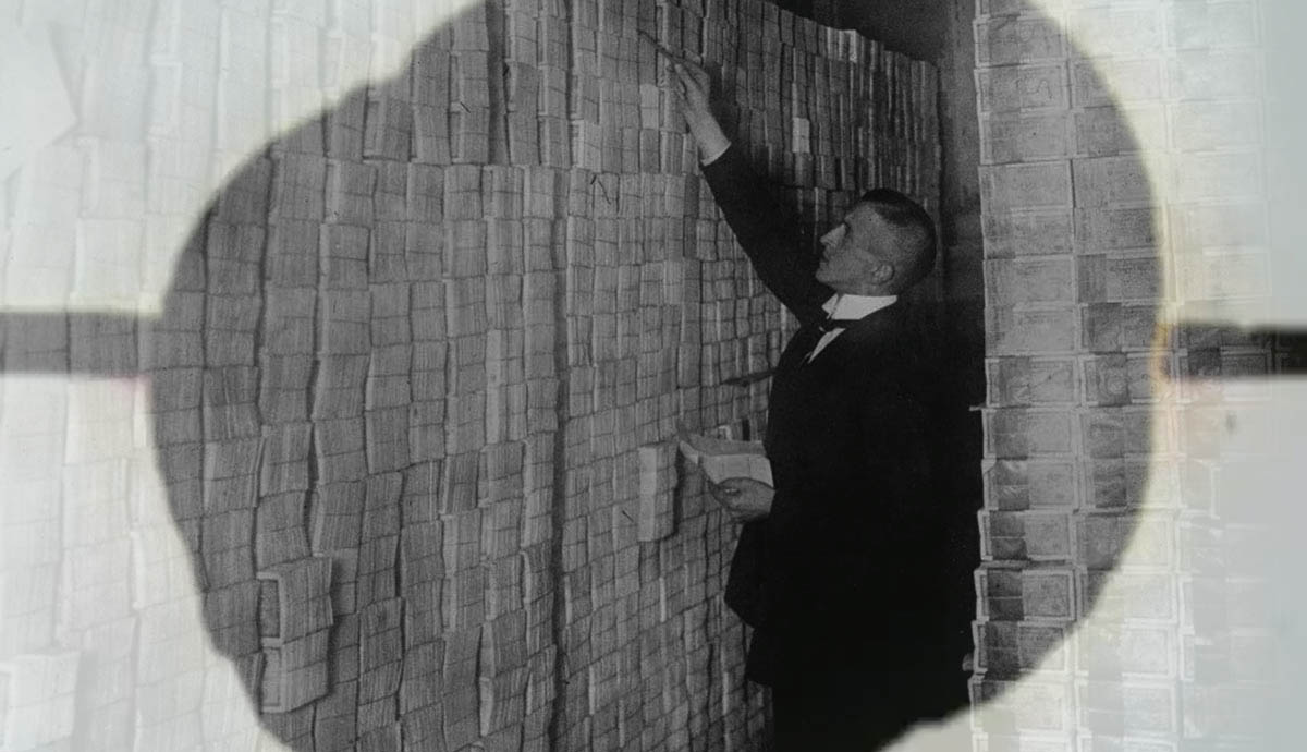 man pilling devalued paper money economic impact post WWI