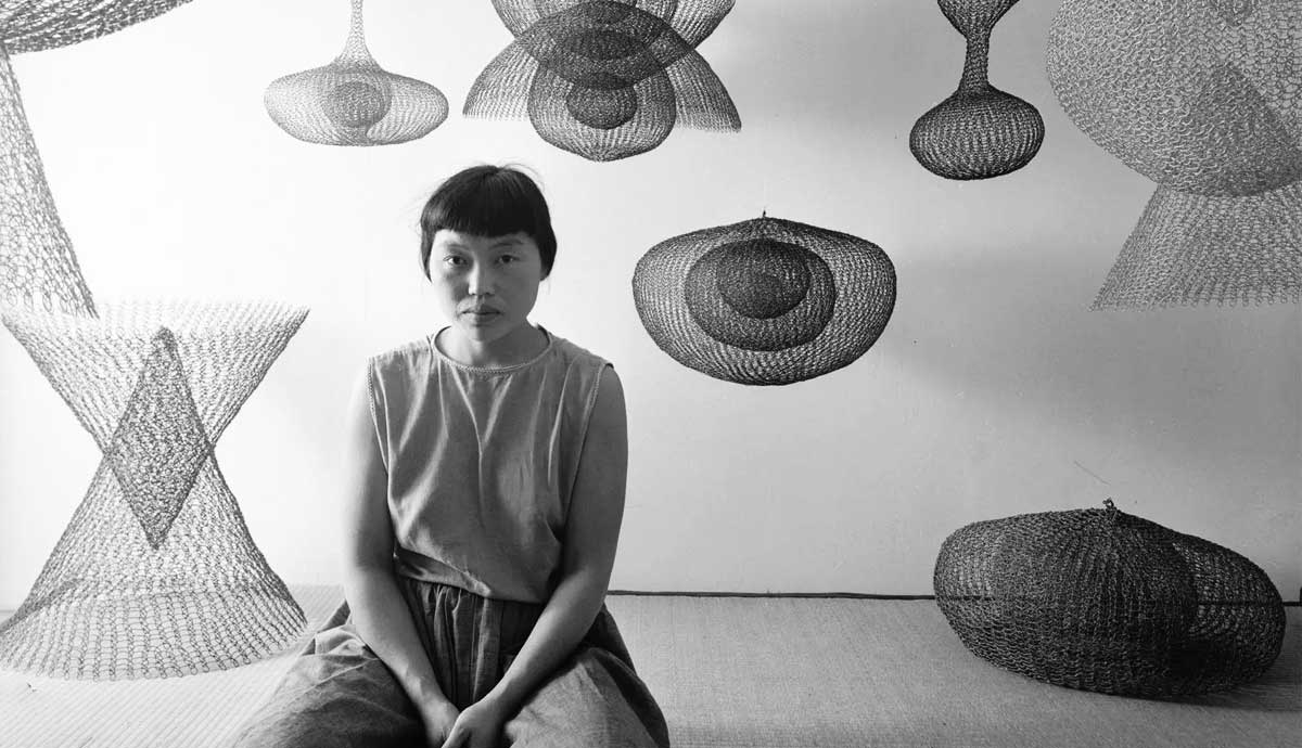 ruth asawa seated with wire sculptures