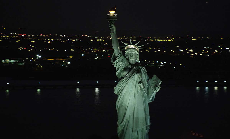 statue of liberty lit up at night