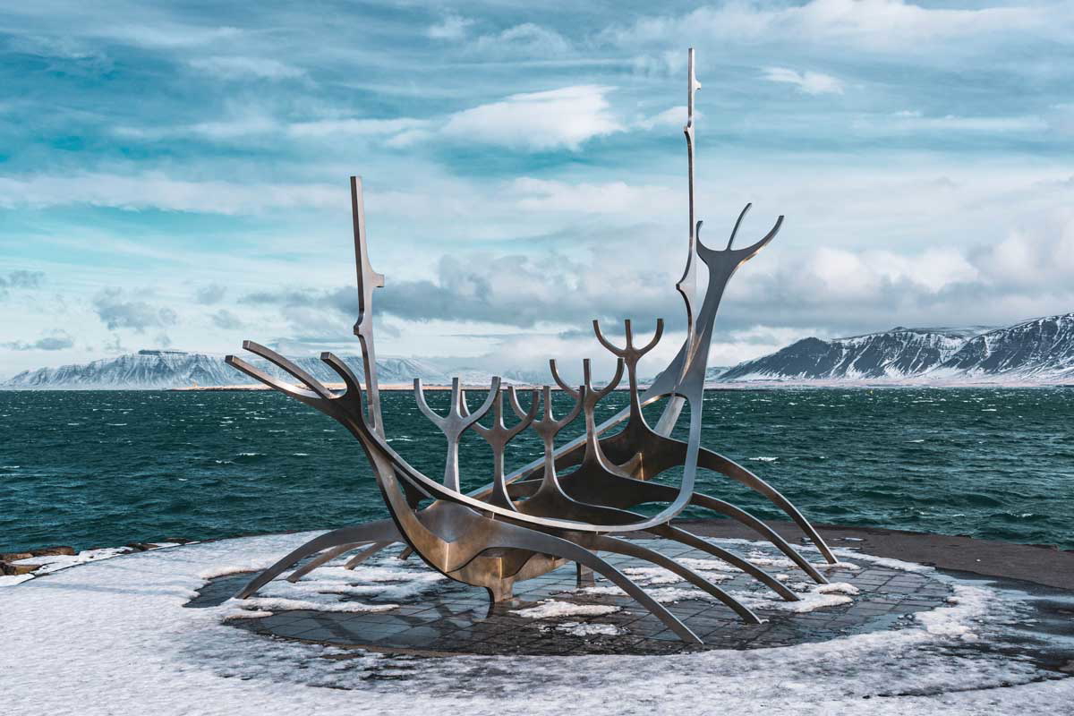 brown wooden boat seashore iceland photograph