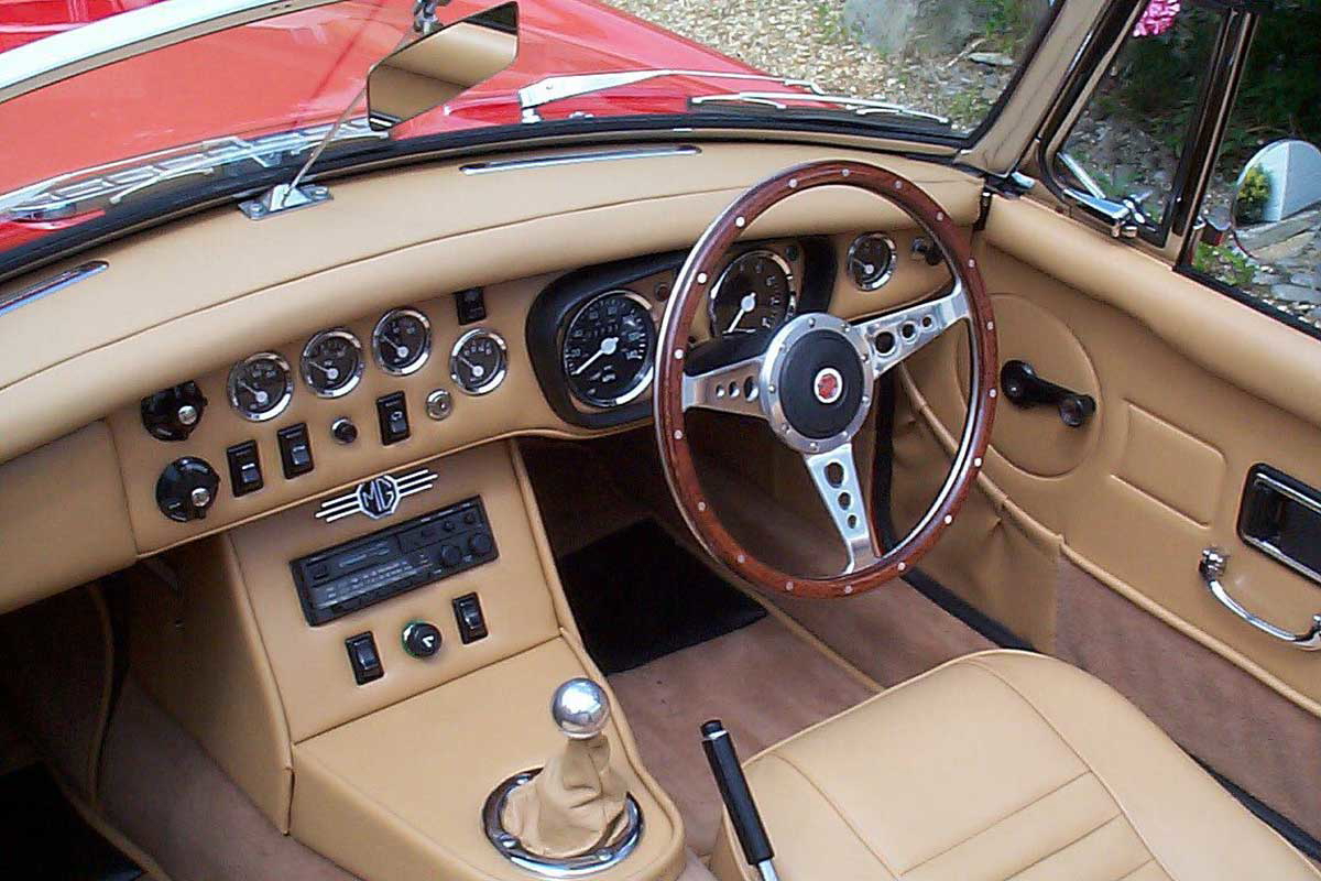 The interior of a classic British car showing the driver’s seat on the right side