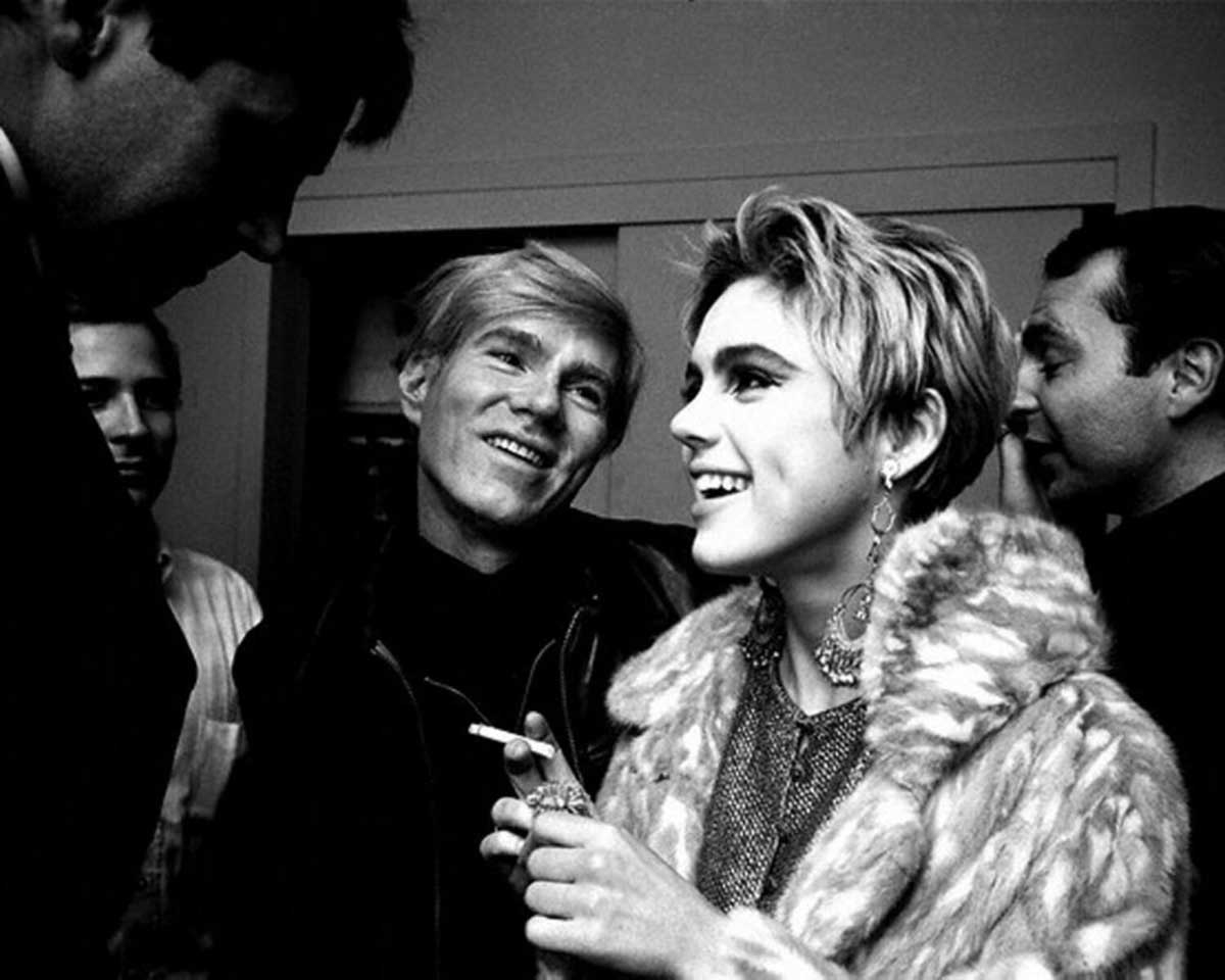 andy warhol looks adoringly at edie sedgwick fur coat