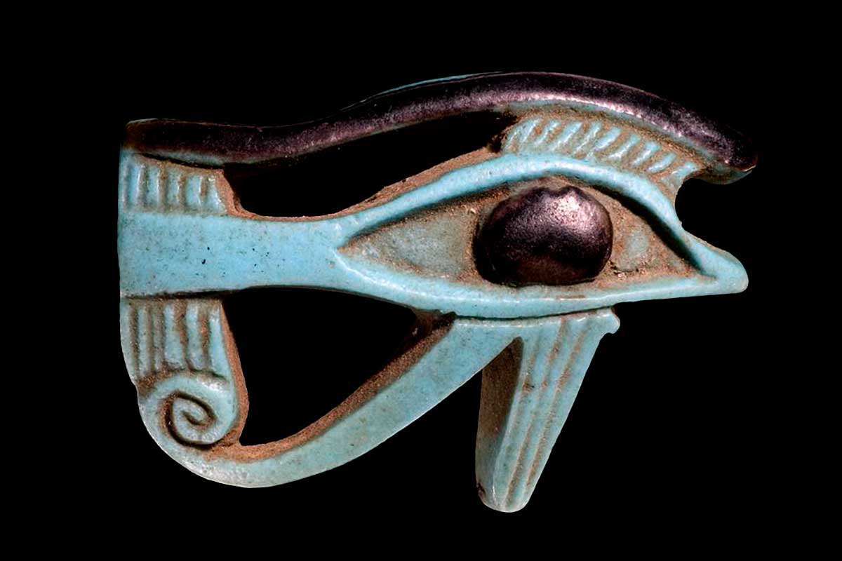Wedjat-eye amulet with a convex face with black detail; pierced longitudinally. Source: The British Museum