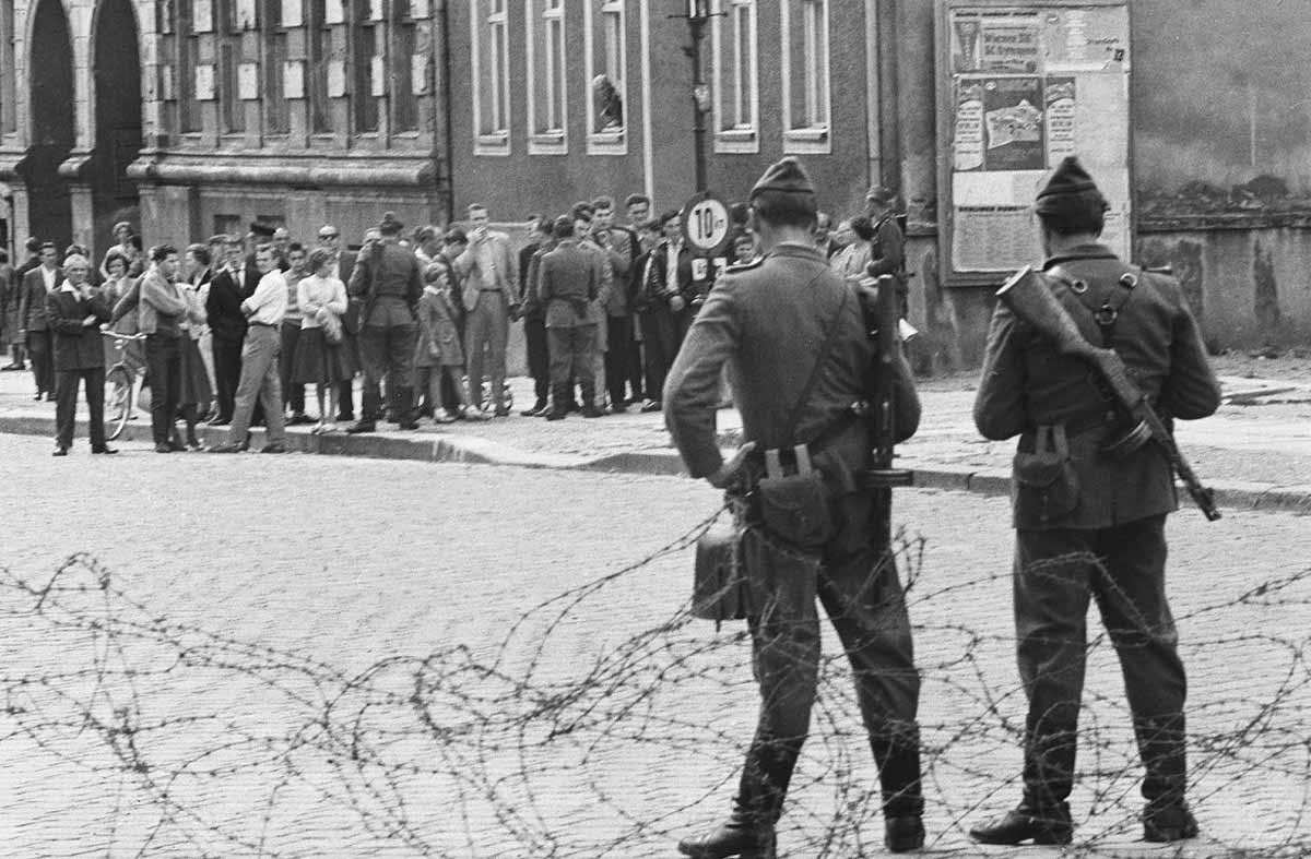 members of the volkspolizei near a barbed wire barrier 13 august 1961