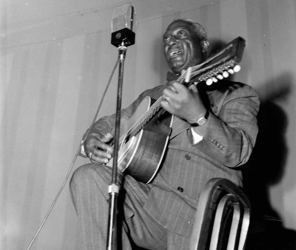 Lead Belly, King of the 12-string guitar, at the National Press Club, Washington DC, between 1938 and 1948, Source: Wikimedia Commons