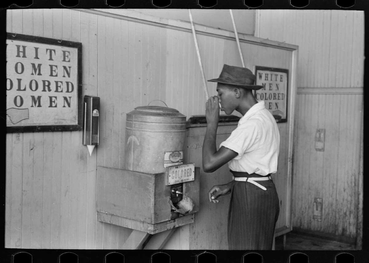 african american boy drinking colored water cooler 1939