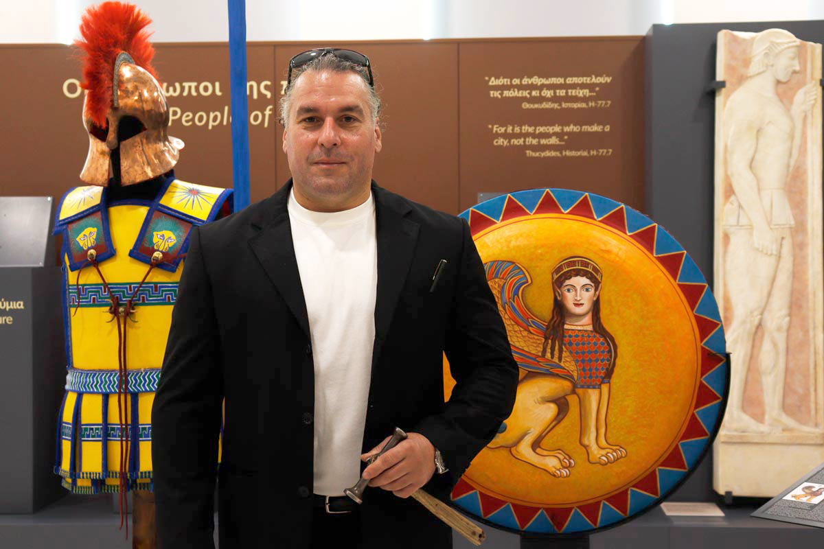 Dimitrios Katsikis in front of his armor and shield of a hoplite of the classical period. Source: A. Chaliakopoulos / TheCollector