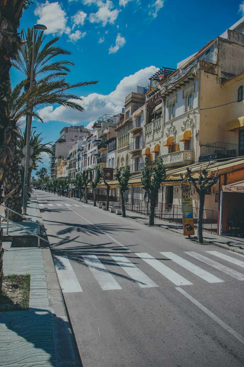 palm lined street sitges day trip barcelona