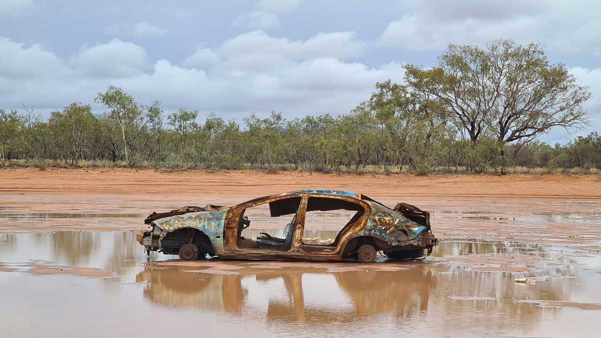 car abandoned river