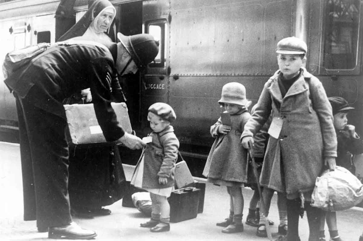 policeman helping child evacuees photo