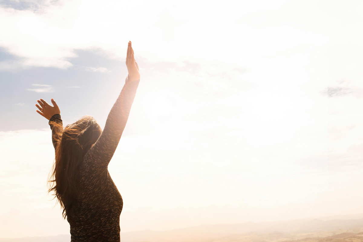 woman raising hands taoism