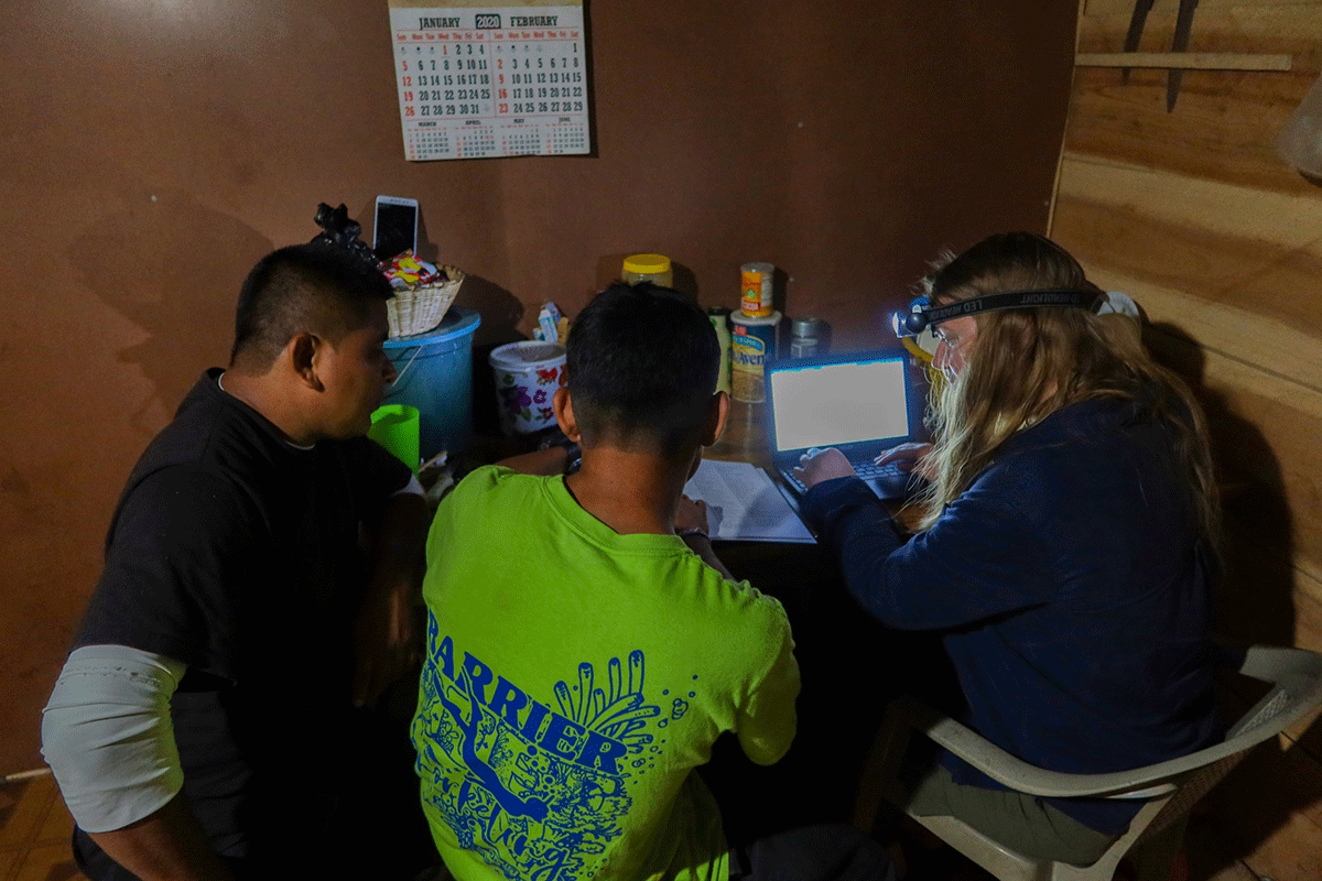 Charlotte two Mopan men translating stories evening