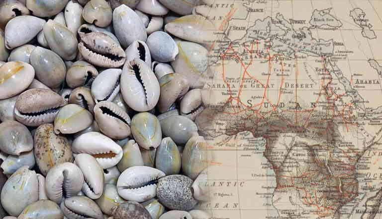 Cowrie shells over vintage Africa map