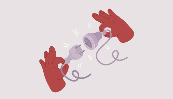 Hands holding disconnected power plug and socket