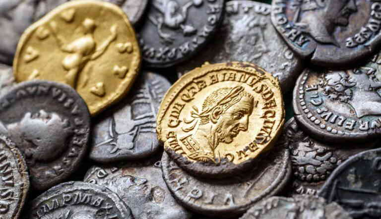 a collection of ancient Roman coins, featuring both gold and silver pieces
