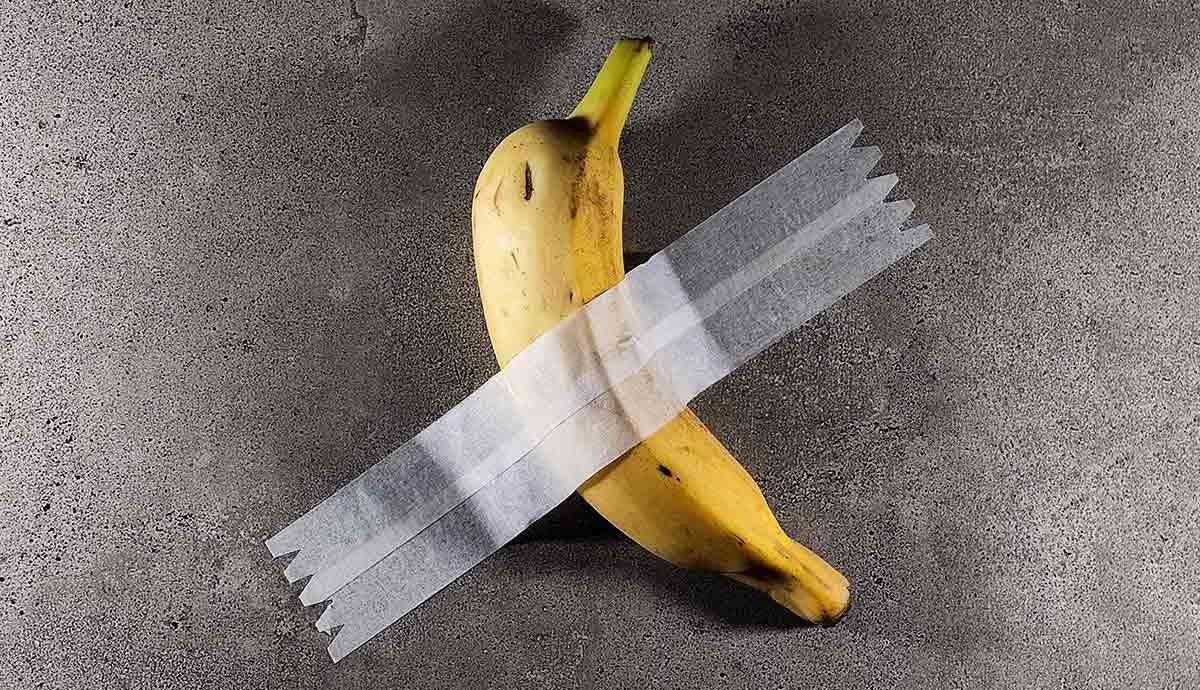 Banana duct-taped to wall artwork