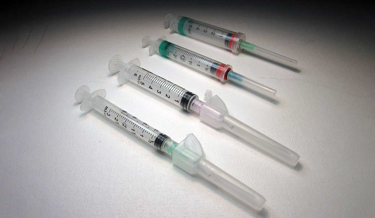 four syringes with needles