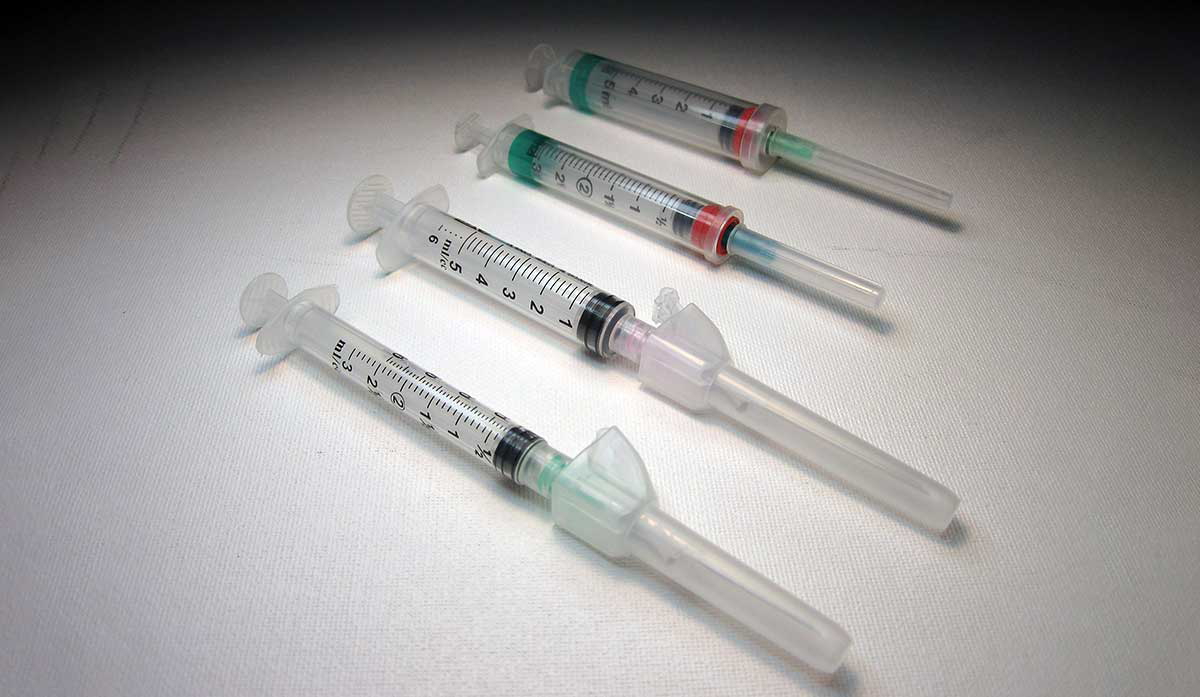 four syringes with needles