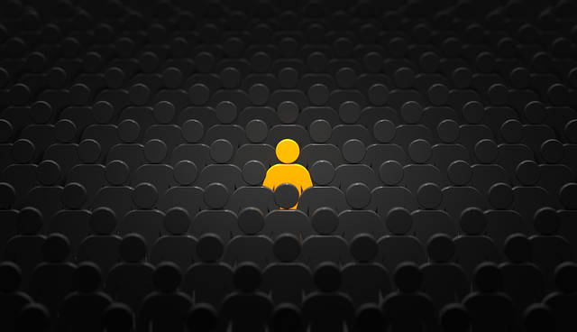 One yellow figure standing out in a crowd