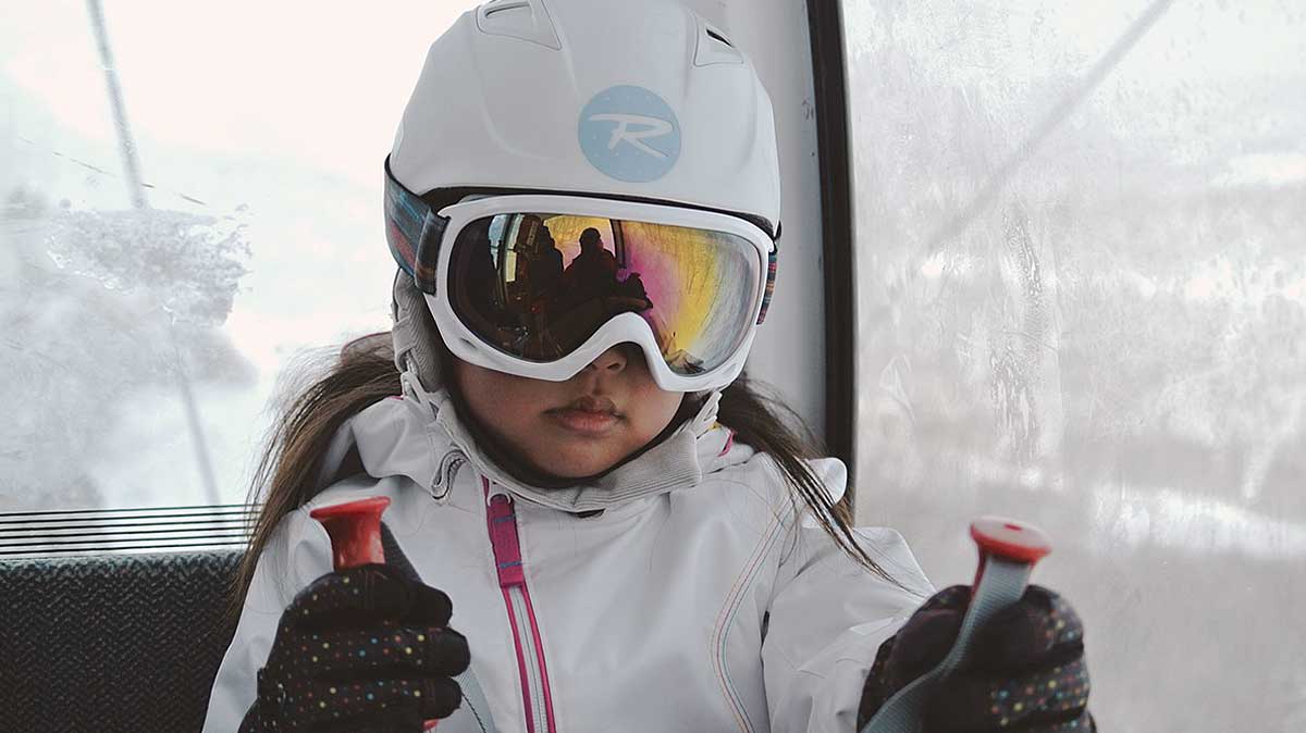 little girl wearing snow goggles