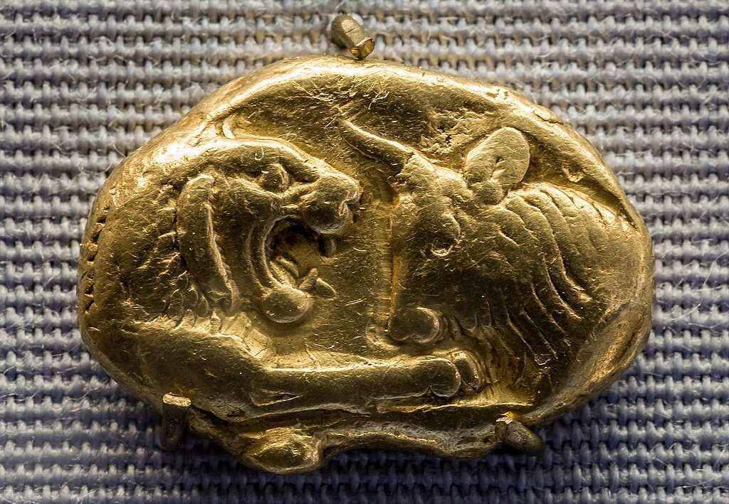 Close-up of Lydian gold stater showing confronted lion and bull, c. 560–546 BCE, early standardized state-issued currency.