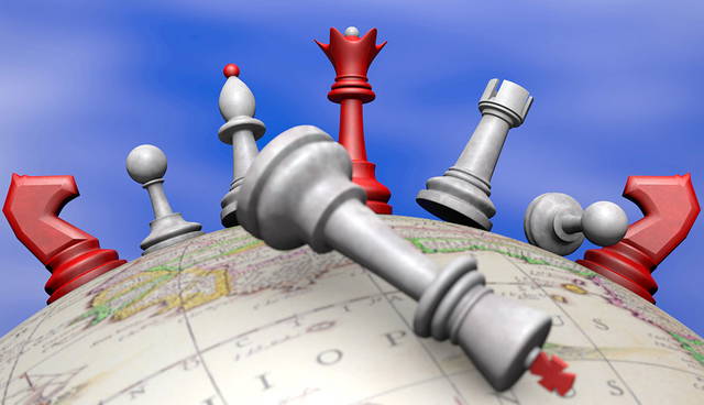 Chess pieces standing on globe symbolizing global strategy