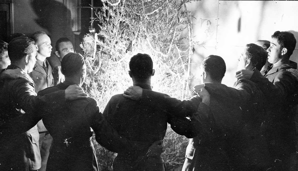 soldiers circled around tree singing