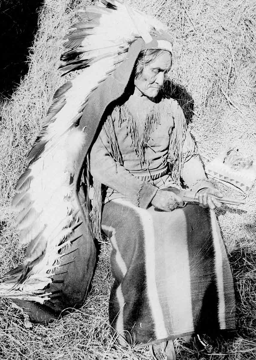 geronimo looking down at pistol