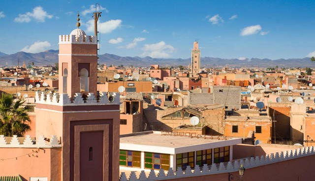 Rooftop view of Marrakech with mosque minarets and cityscape