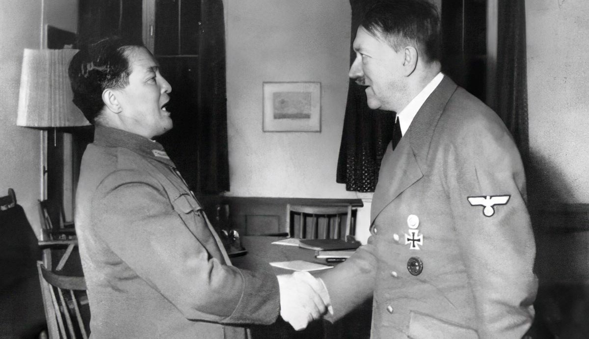 Two political leaders shaking hands indoors