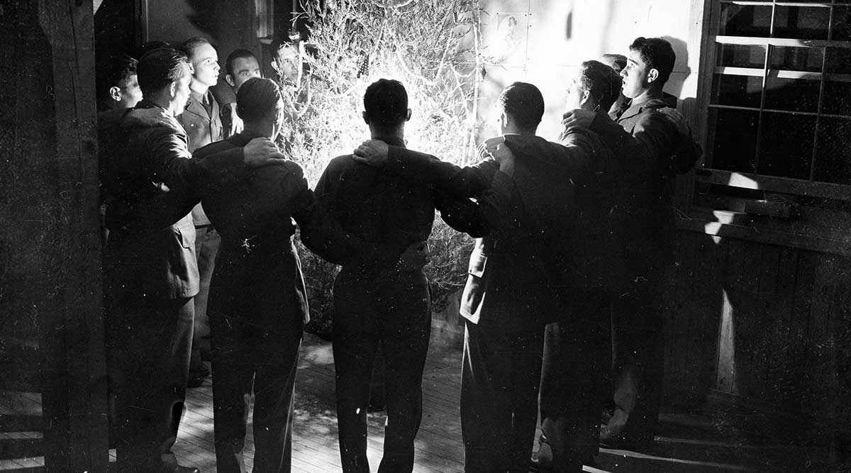 soldiers circled around tree singing