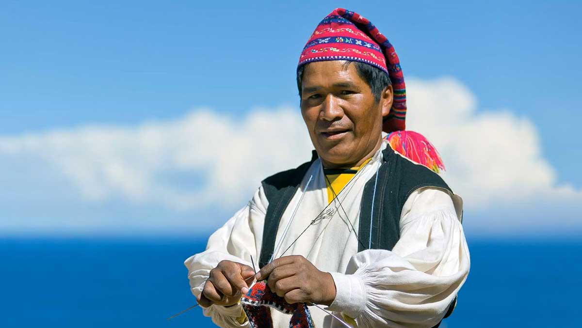 taquile man traditional dress knitting