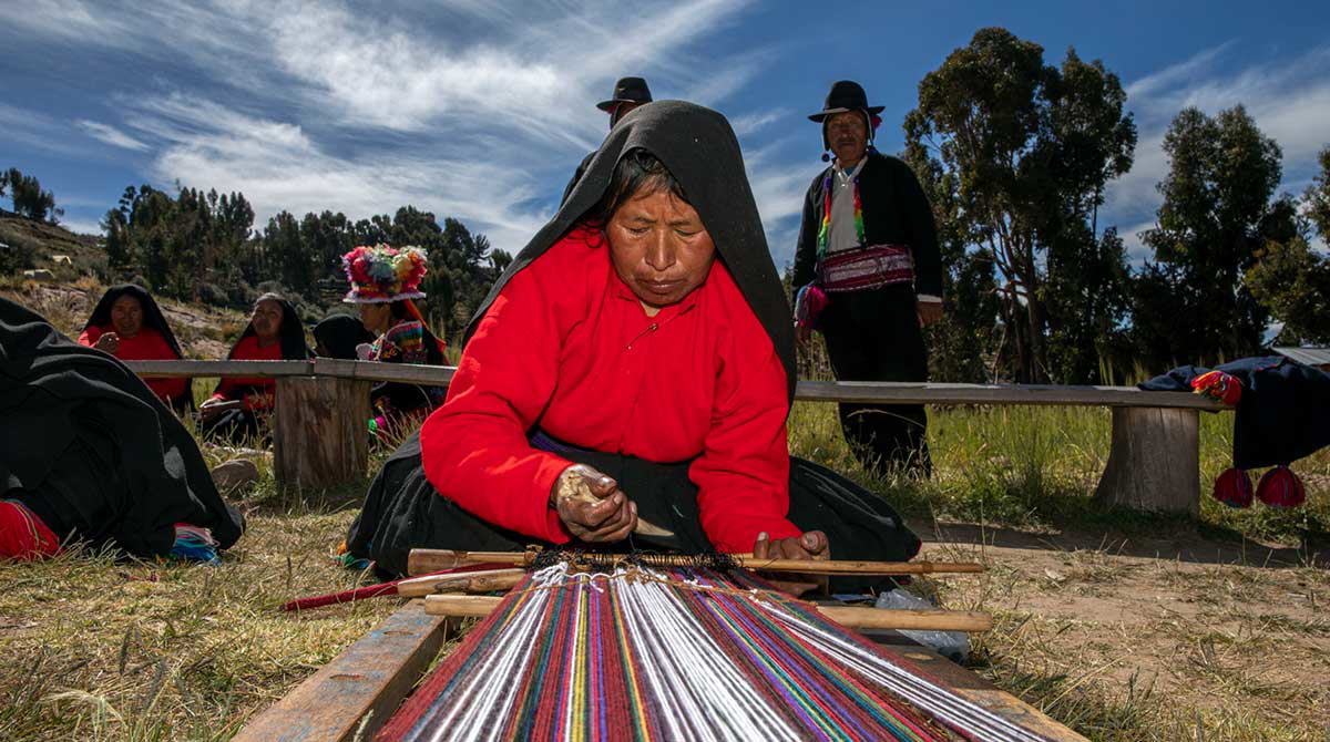 taquile woman weaving ground loom