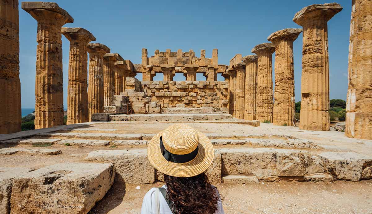 Visitor facing ancient temple ruins