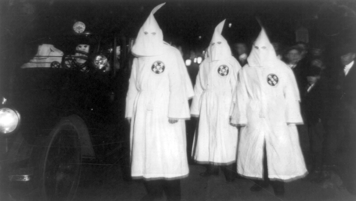 kkk members beside car