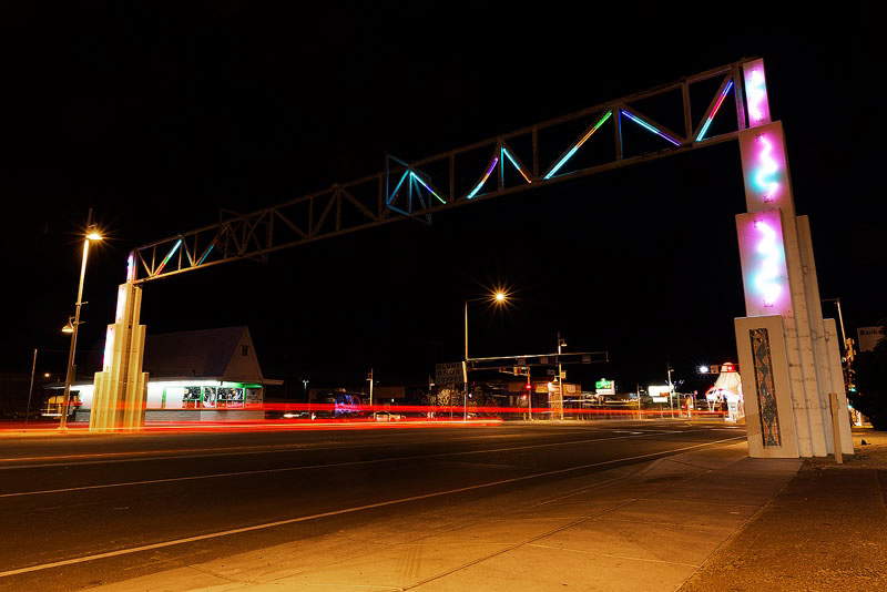 Illuminated Route 66 neon arch spanning Central Avenue in the Nob Hill neighborhood of Albuquerque, New Mexico