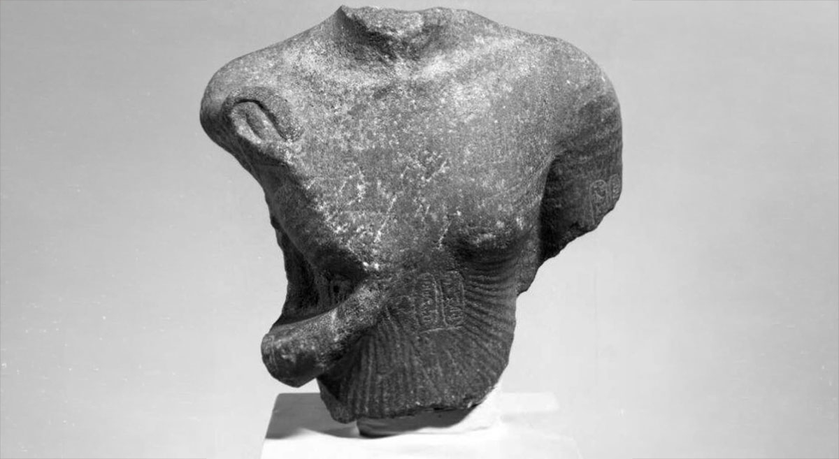 Statue of Akhenaten missing its head and arms and with numerous abrasions, suggesting deliberate defacing, c. 14th century