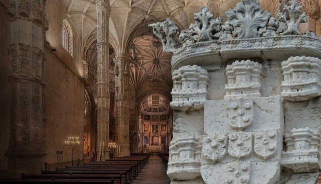 Interior of the Jerónimos Monastery in Lisbon beside the Portuguese coat of arms