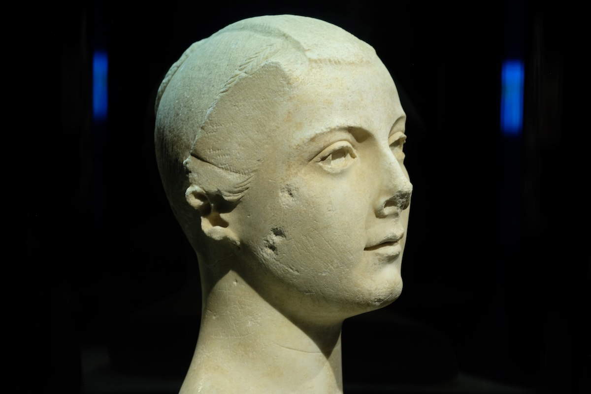 Marble portrait of the Torlonia Maiden with delicate features and a styled hairdo, exhibited at the Montreal Museum of Fine Arts.