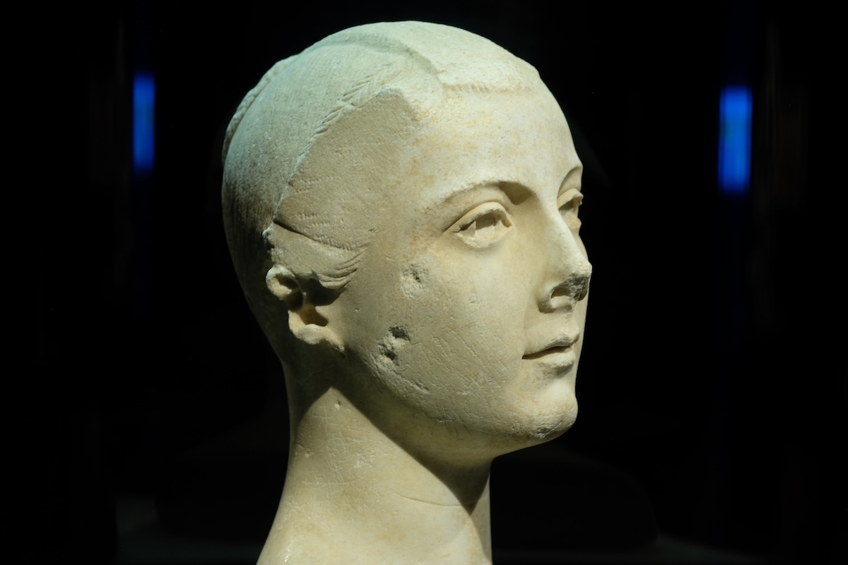 Marble portrait of the Torlonia Maiden with delicate features and a styled hairdo, exhibited at the Montreal Museum of Fine Arts.