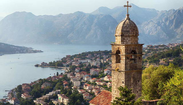 Stone church tower overlooking coastal town