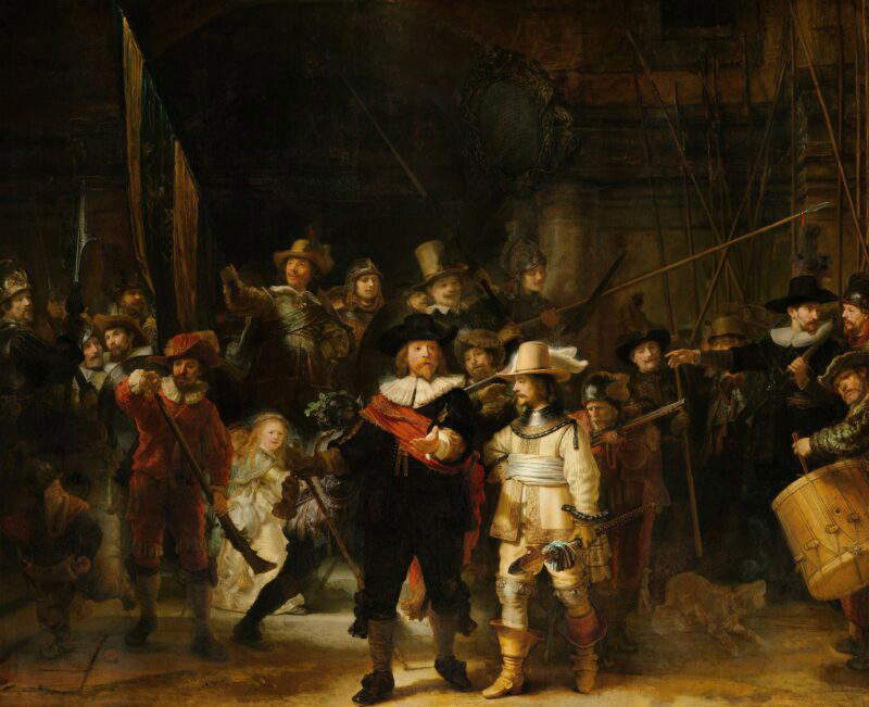 A monumental Baroque oil painting featuring a large group of Dutch civic guardsmen emerging from a dark, shadowed archway into a burst of dramatic light. At the center, Captain Frans Banninck Cocq, dressed in black with a red sash, gestures forward while speaking to Lieutenant Willem van Ruytenburch, who wears ornate yellow-gold attire. To the left, a young girl in a glowing gold dress, with a dead chicken hanging from her belt, acts as a symbolic mascot. The scene is filled with kinetic energy, featuring men holding pikes, muskets, and a large unfurled flag against a backdrop of complex architectural shadows.